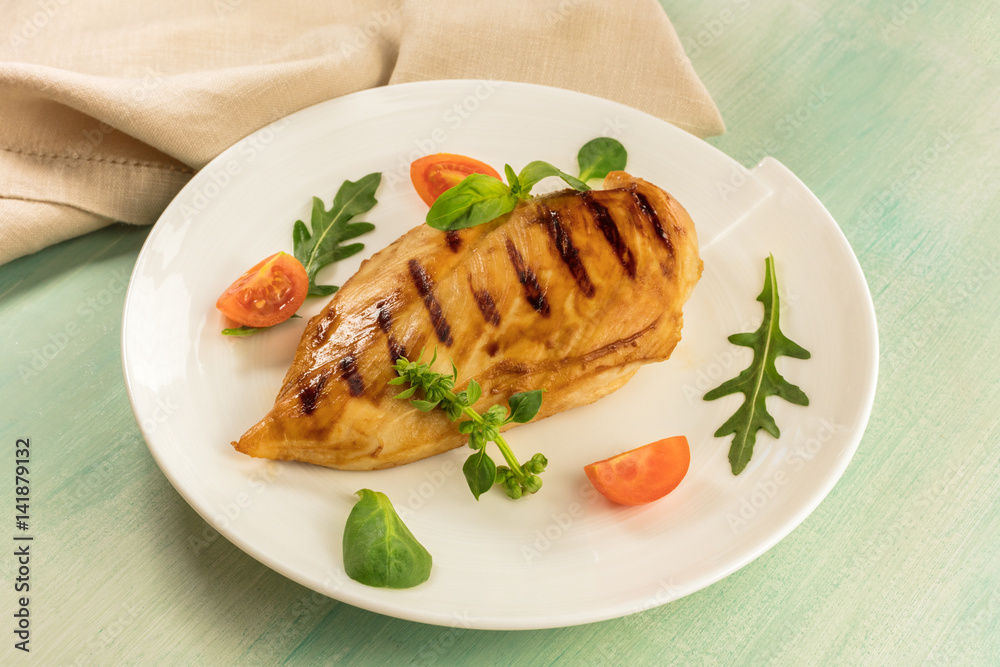 Grilled chicken fillet with cherry tomatoes and salad leaves Grilled chicken fillet with cherry tomatoes and salad leaves