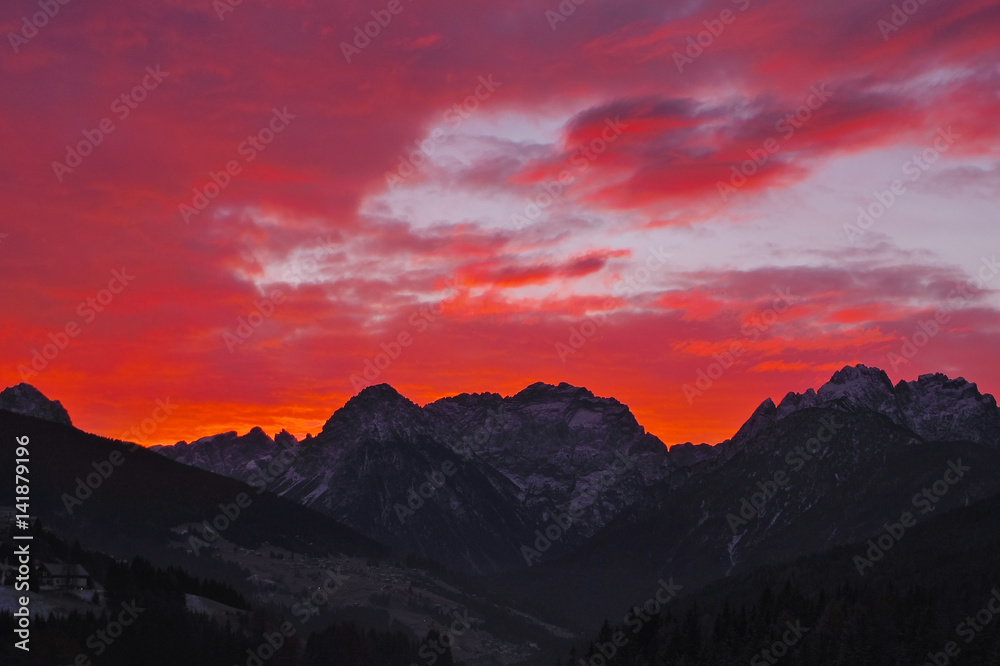 Red scenic sunset over the Dolomites of Comelico