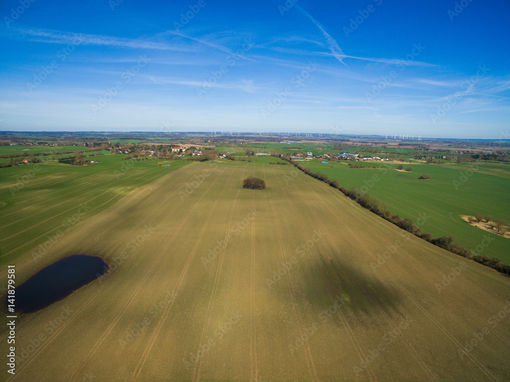 Aerial view of a green rural area agricultural fields under blue sky in germany