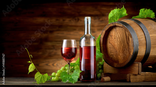 Fototapeta Naklejka Na Ścianę i Meble -  Wine bottle and glasses with wooden barrel on the table