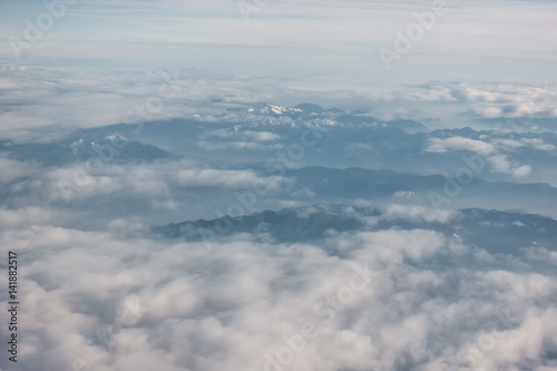 Aerial view of snowy mountains and clouds