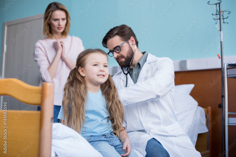 Fototapeta premium Mother and daughter visiting doctor