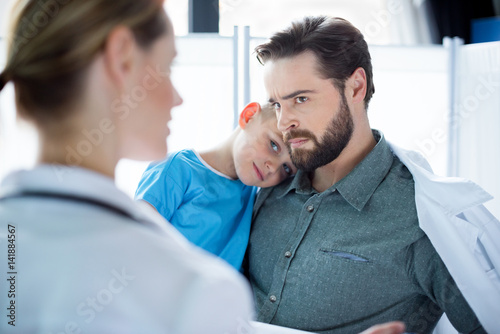 Father and son visiting doctor