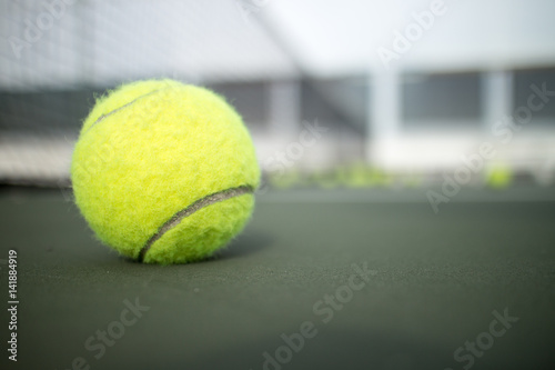 Tennis ball on tennis hard court © icedmocha
