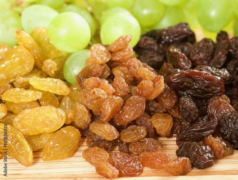 raisins on a wooden background raisins on a wooden background