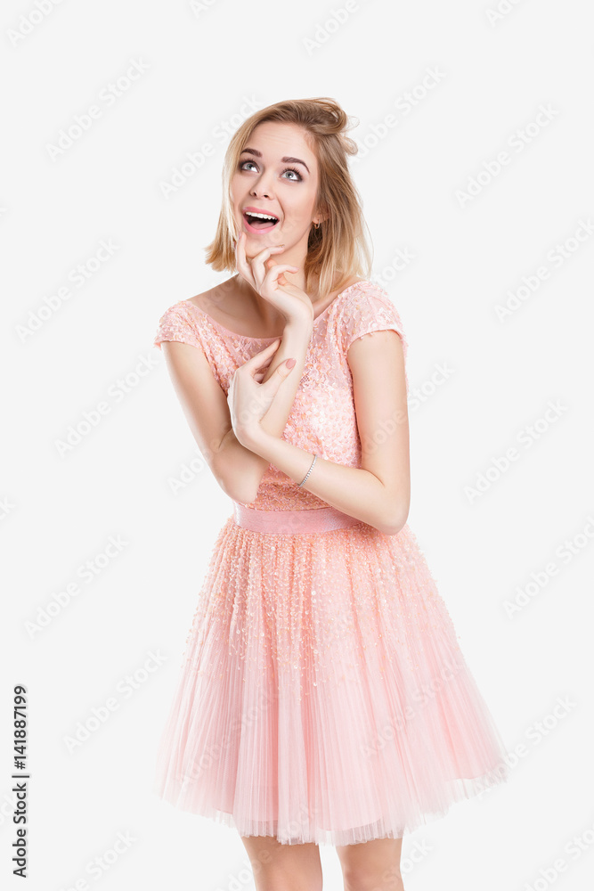 portrait of beautiful blond sensual woman in pink cocktail dress on grey background portrait of beautiful blond sensual woman in pink cocktail dress on grey background