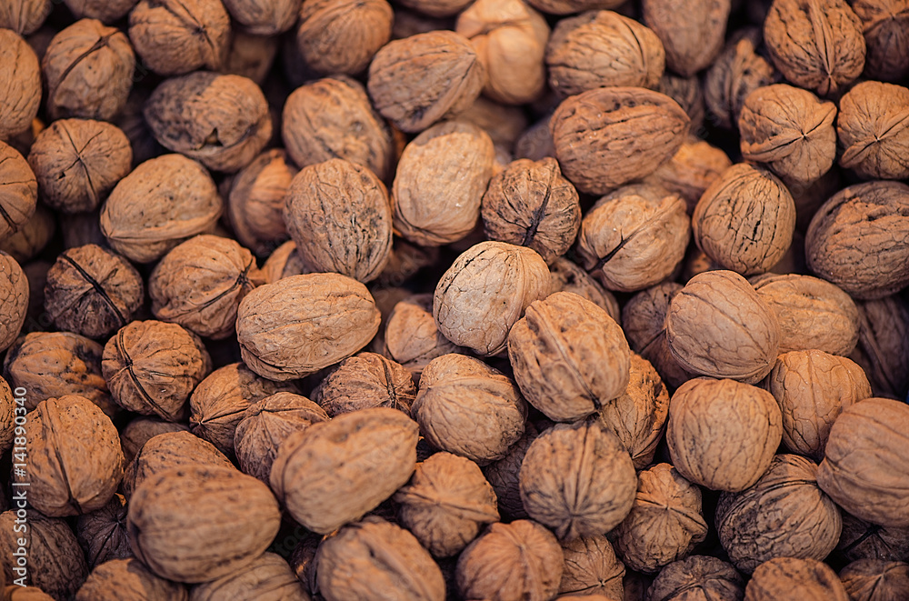 Many walnuts for sale. Walnuts texture and background. Healthy organic food concept. View above Many walnuts for sale. Walnuts texture and background. Healthy organic food concept. View above