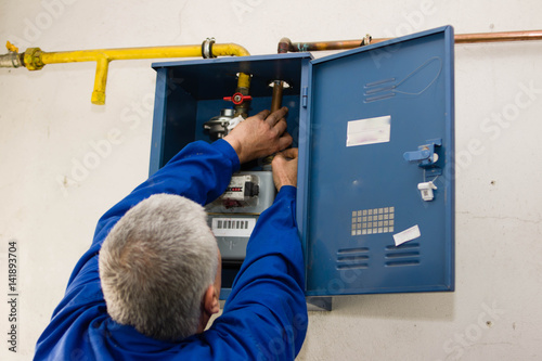 worker repaired a gas meter of methane