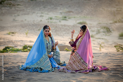 Persia or Iran Women's sitting talking joyful and relaxing on sand or Beach.