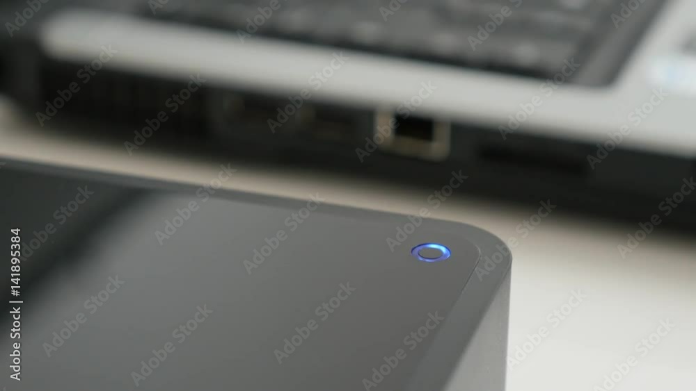 USB external hard disc saving data from connected laptop computer 4K 2160p 30fps UltraHD footage - Black storage device LED status lamp blinks 3840X2160 UHD video USB external hard disc saving data from connected laptop computer 4K 2160p 30fps UltraHD footage - Black storage device LED status lamp blinks 3840X2160 UHD video