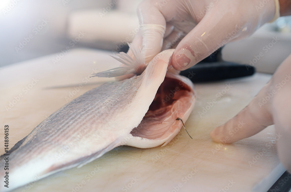 Fisherman cutting raw fish