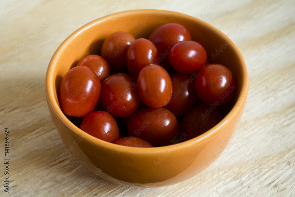 Tomatoes cherrys fresh in bowl for salads, catering, fast foods Tomatoes cherrys fresh in bowl for salads, catering, fast foods