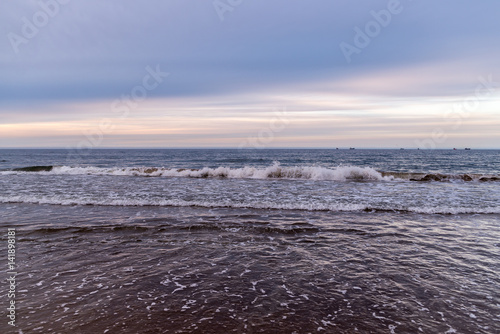 Waves on beach in sunset time. Baltic sea, Gdansk.