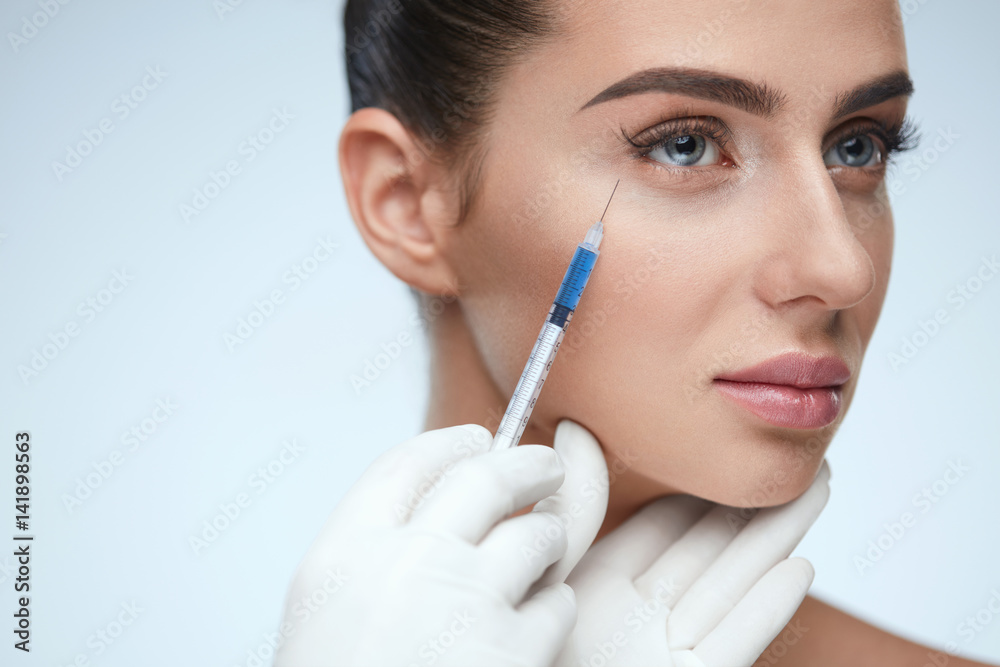 Woman Face Receiving Beauty Injections In Skin Woman Face Receiving Beauty Injections In Skin