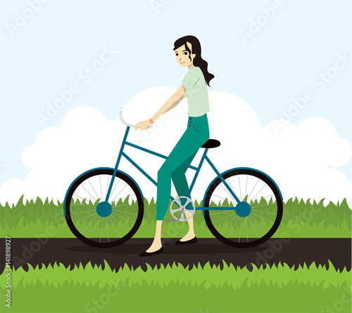 Fototapeta Naklejka Na Ścianę i Meble -  Active young woman riding on bicycle
