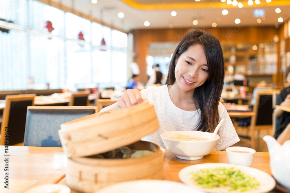 Woman enjoy the meal in chinese restaurant