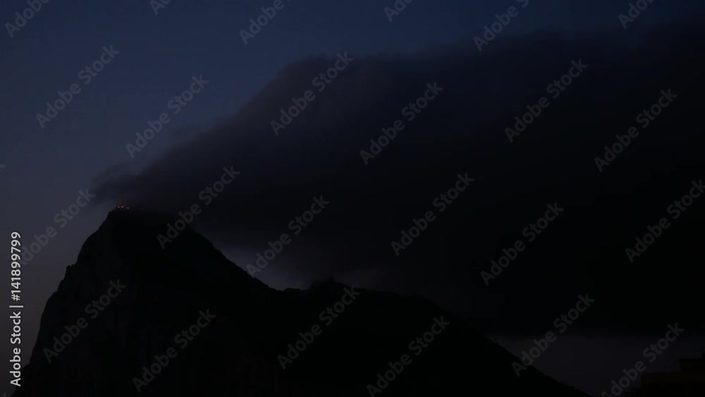 Dawn time-lapse of the Rock of Gibraltar with morning cloudy sky, UK. Dawn time-lapse of the Rock of Gibraltar with morning cloudy sky, UK.