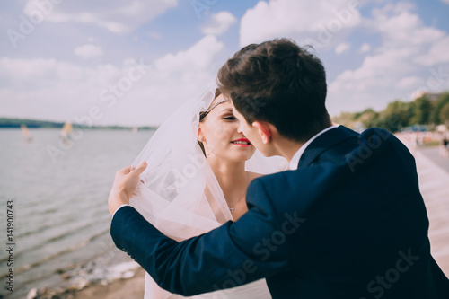 Elegant young bride and groom on the beach