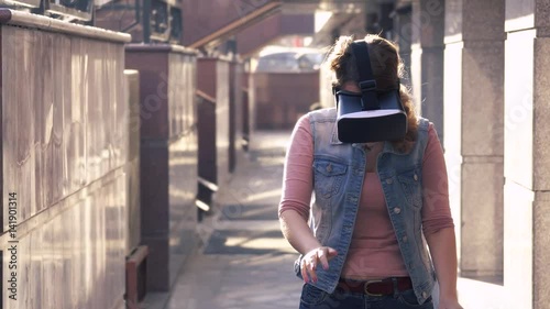 woman uses a virtual reality glasses in modern architecture photo