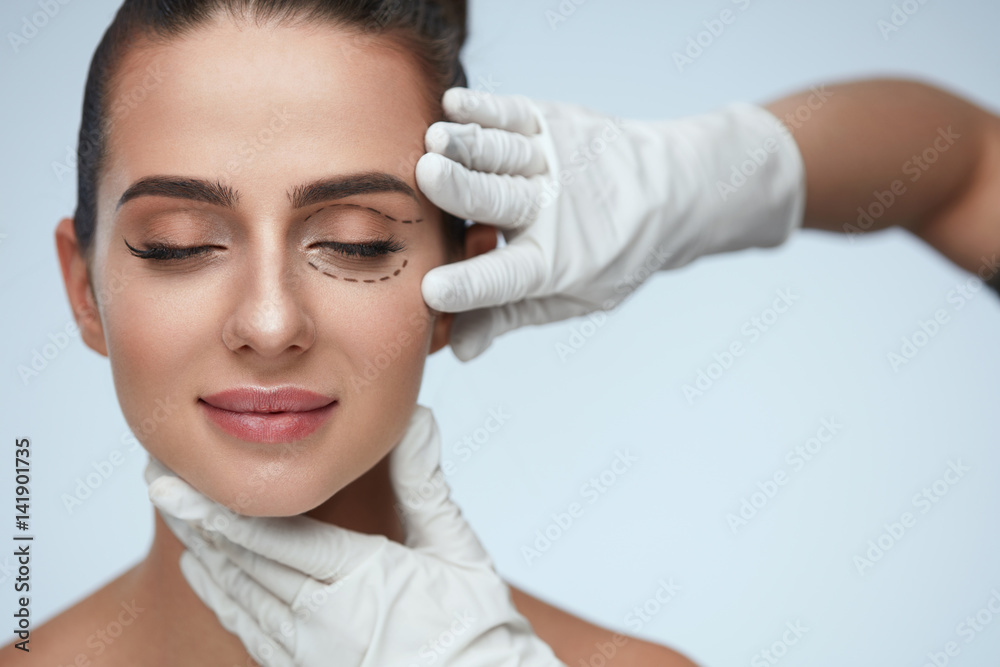 Closeup Of Beautician Hands Touching Young Female Patient Face Closeup Of Beautician Hands Touching Young Female Patient Face