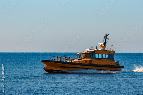 Yellow pilot ship moving at speed from the Baltic sea © InfinitumProdux