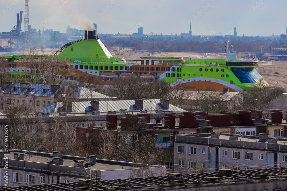 Green cruise liner. Passenger ferry sailing past the Riga city Green cruise liner. Passenger ferry sailing past the Riga city