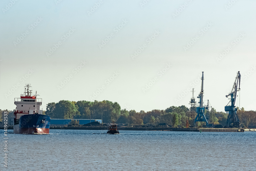 Blue cargo ship leaving the port of Riga
