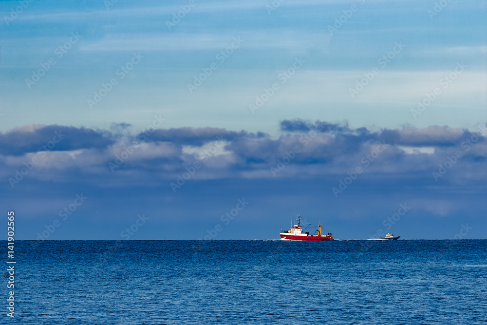 Red fishing ship sailing far in the Baltic sea. Europe Red fishing ship sailing far in the Baltic sea. Europe