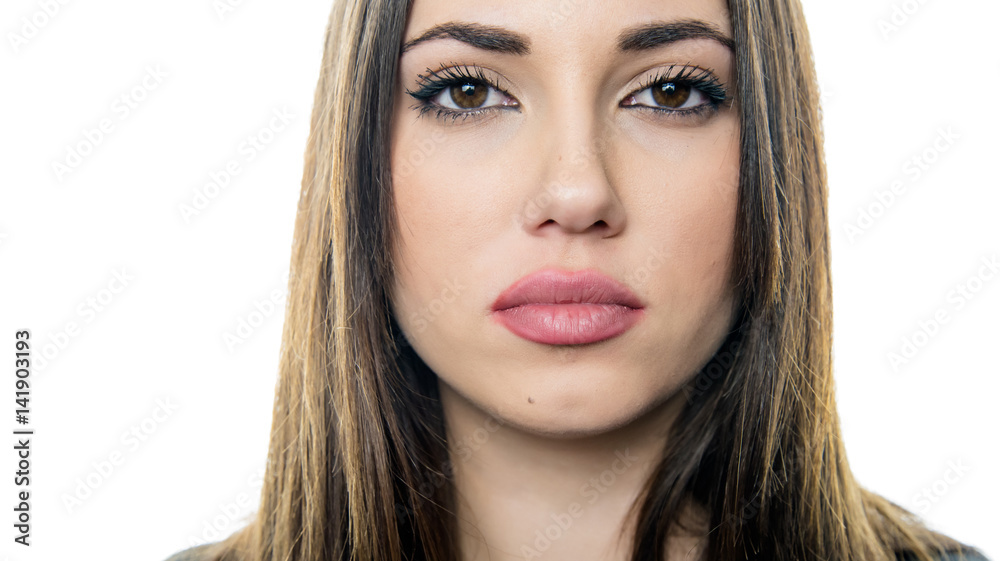 Pretty young woman look at the camera with poker face, isolated white  background Stock Photo | Adobe Stock