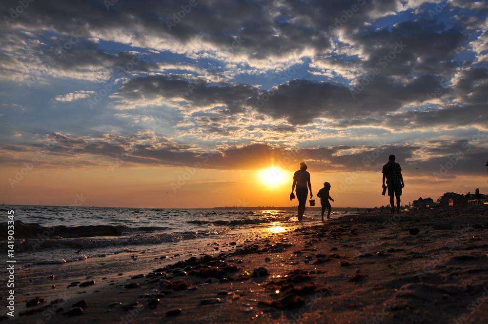 Couple on the beach with a baby Couple on the beach with a baby