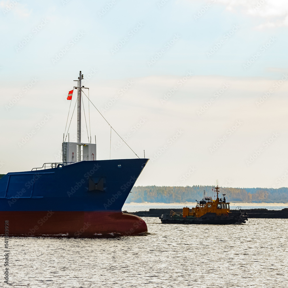 Fototapeta premium Blue cargo ship's bow leaving the port of Riga