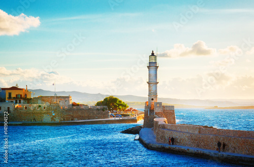 bay of Chania with sea and lighthouse at sunny summer sunset, Crete, Greece, retro toned