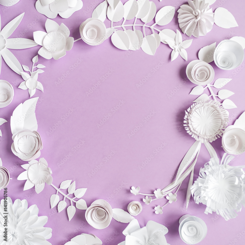 round frame with paper flowers on the purple background