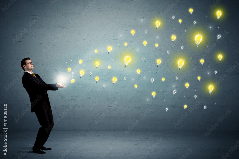 Businessman holding lightbulbs Businessman holding lightbulbs