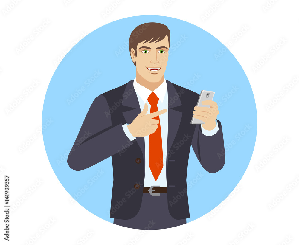 Businessman pointing at a mobile phone in his hand Businessman pointing at a mobile phone in his hand