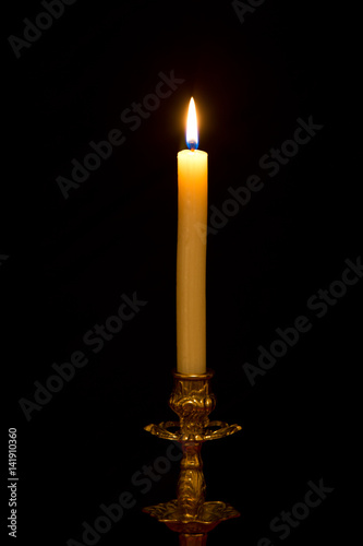 Chandelier with burning candle on black background