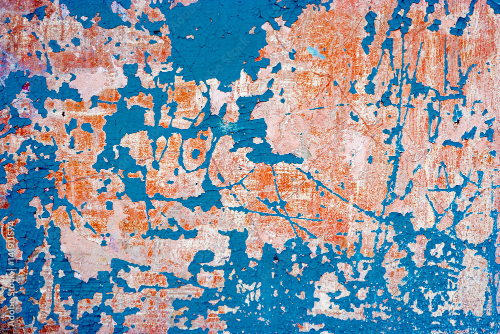 Abandoned wall with blue paint on. Grungy background with weathered plaster and destroied paint