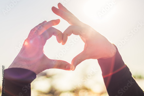 Wallpaper Mural Heart from hands in the background of the sun Torontodigital.ca