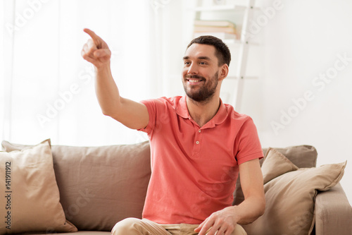 Tableau sur toile happy man touching something imaginary at home