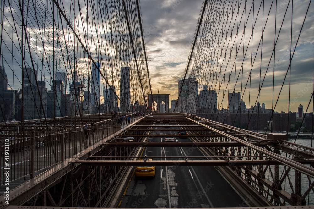 Naklejka premium Downtown Manhattan Skyline in New York as Seen from Brooklyn Bridge during Sunset, USA