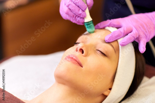 woman having microdermabrasion facial treatment
