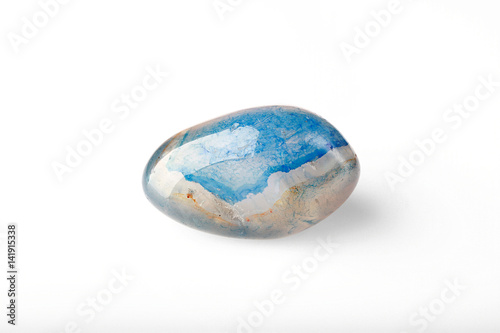 Polished blue agate stone on a white background.