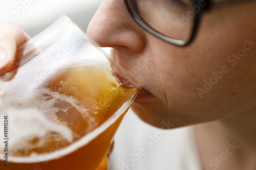 young woman drinks beer - lager