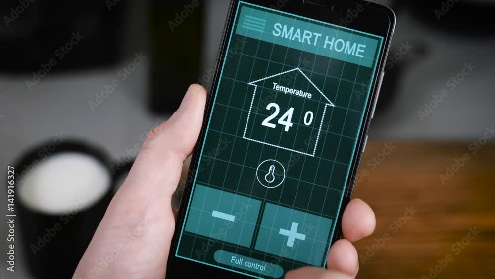 Svart House. Remote home control system on a digital tablet or phone. Men's hands hold a smartphone with an active application for managing the house.