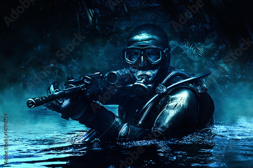 Combat diver of special forces operations unit frogmen comes up in jungle in diving gear. Dark night, moonlight, diversionary operation with weapon photo