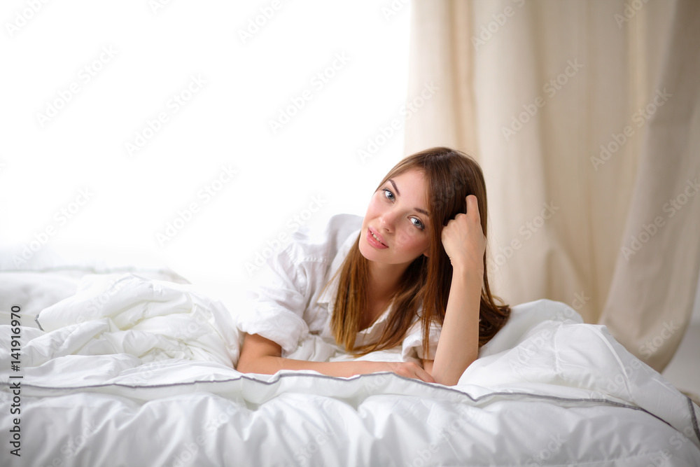 Portrait of beautiful woman on bed at bedroom Portrait of beautiful woman on bed at bedroom