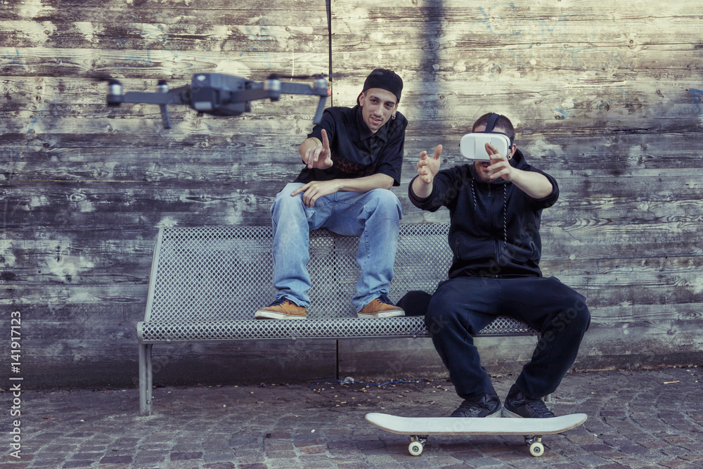 young guys are flying a drone with remote control outdoor young guys are flying a drone with remote control outdoor