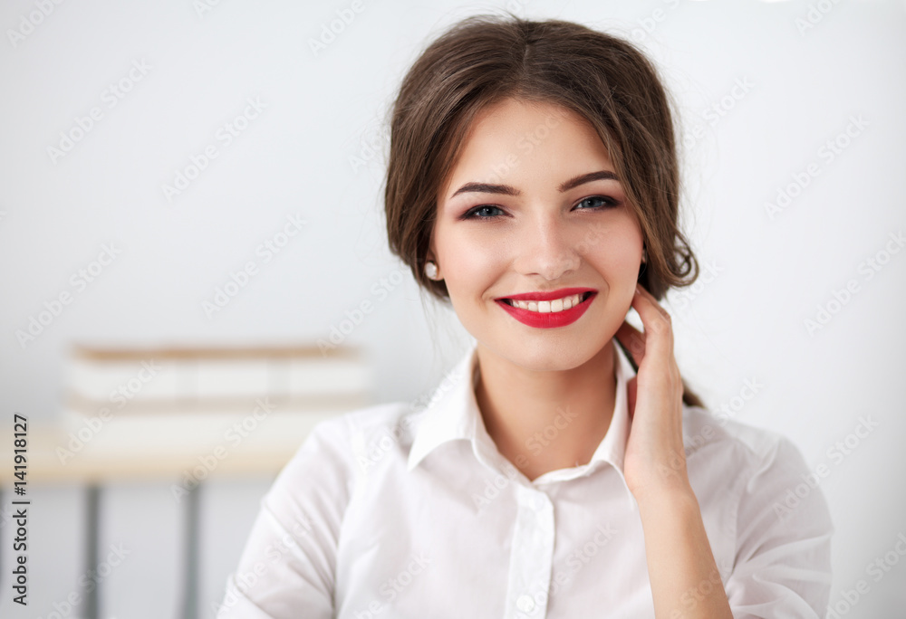 Attractive businesswoman sitting in the office Attractive businesswoman sitting in the office