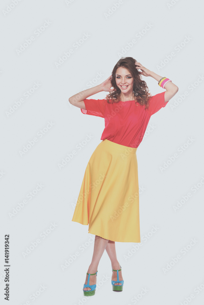 Beautiful woman with curly hair wearing a red jacket, isolated on white background Beautiful woman with curly hair wearing a red jacket, isolated on white background