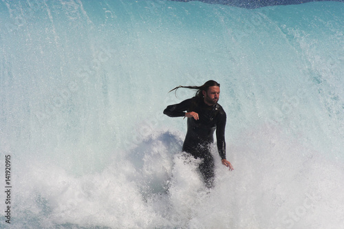 A big wave catch's up with this surfer. photo